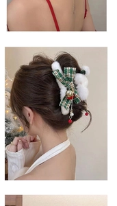 Detail of Christmas plush hair claw clip with green bow and bell tassel on model