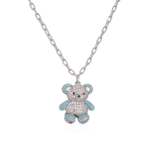 Close-up of a silver teddy bear pendant with sparkling blue and white zircon stones