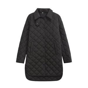 Detailed view of black diamond-quilted pattern and texture on a long winter jacket