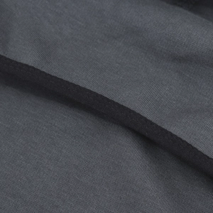 Macro detail of dark grey thick brushed fabric texture and neat stitching on head cover