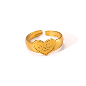 Macro shot of gold heart ring with eye engraving and adjustable open band design