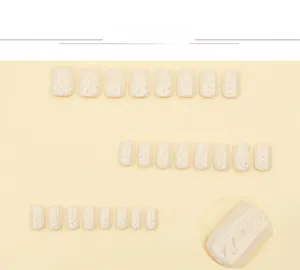 Detail view of milky white press-on nails with 3D embossed knit texture matte finish