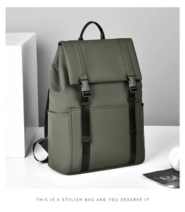 Detail view of olive green backpack featuring matte texture and dual buckle flap closure