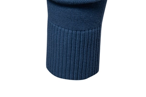 Detailed close-up of dark blue ribbed cuffs and fine knit texture on a men's V-neck sweater