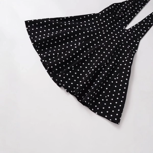 Fashionable black and white polka dot V-neck halter dress in a flat lay presentation