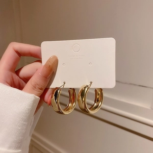 Minimalist thick golden geometric hoop earrings with 925 silver posts on display card