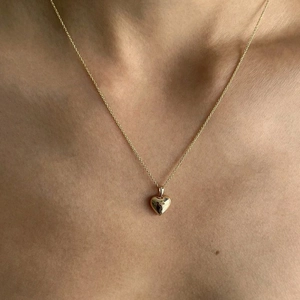 Elegant 925 sterling silver heart pendant necklace in gold worn by a model
