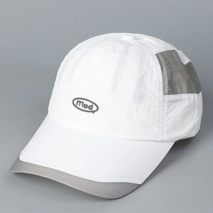 Close-up of quick-dry white baseball cap with grey mesh panels and embroidered Mad logo