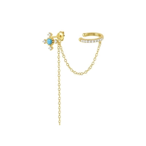 Close-up of golden sterling silver cross stud connected to a zircon ear cuff with chain