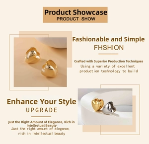 Detail view of heart-shaped earrings in polished 18k gold and silver stainless steel