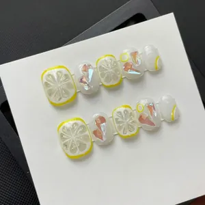 Handmade 3D lemon press-on nails set with yellow relief and crystals on white card