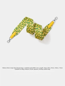Detail of yellow leopard print woven bag strap with silver clasps and cowhide ends