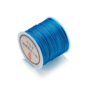 Macro shot of 0.8mm blue nylon cord spool for DIY jewelry making and knotting