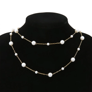 Double-layered 18K gold-plated chain necklace with white pearls on a black display