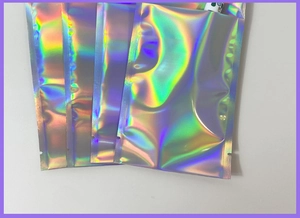 Close-up of holographic laser resealable bags with iridescent rainbow metallic finish