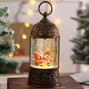 Close-up of vintage bronze Christmas lantern music box with Santa and snow globe
