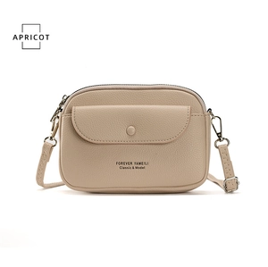 Front view of apricot leather phone bag with magnetic flap pocket and zipper closure