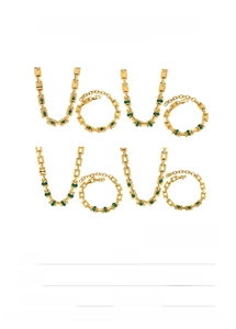 Detail of gold stainless steel necklace and bracelet set with green rectangle gemstones