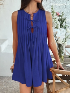 Detail of blue sleeveless pleated mini dress featuring a front tie-up neckline design