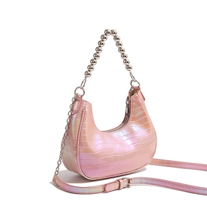 Detail of pink pearlescent crescent bag with crocodile pattern and silver bead chain