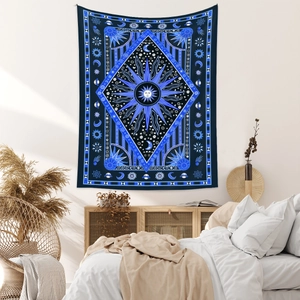 Detailed view of bohemian sun and moon tapestry hanging on a bedroom wall decoration
