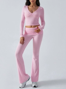 Detail of pink knitted V-neck crop top and flared pants set with a soft elastic texture