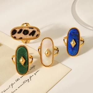 Detailed view of vintage oval 18K gold plated rings with natural stone and mother of pearl
