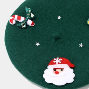 Detailed close-up of Christmas beret featuring Santa patch, ribbon and star studs