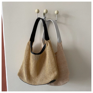 Detail of summer woven hobo bags with stylish black and white PU leather straps