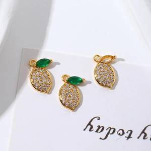 Detail of 18K gold-plated lemon charms with clear cubic zirconia and green leaves