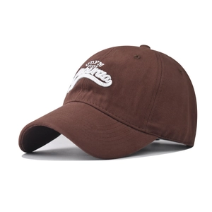 Detailed close-up of 3D white embroidery on a deep brown cotton baseball cap crown