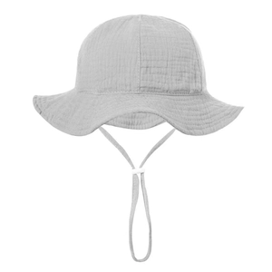 Detail of light grey cotton gauze baby sun hat with wavy brim and adjustable chin strap