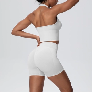 Side view of white seamless knitted yoga set with halter neck crop top and high waist shorts