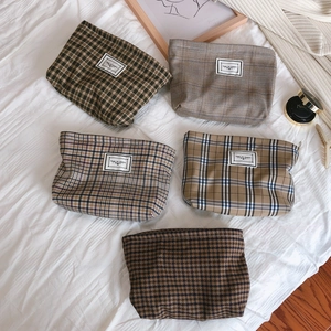 Retro plaid storage bags set in earth tones with TIME TO PARTY label on white cloth