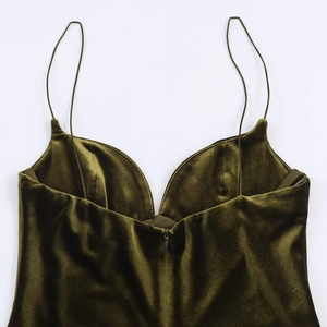 Détail d'une robe en velours vert olive avec fines bretelles et fermeture éclair invisible