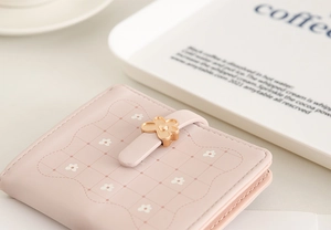 Close-up of pink PU leather short wallet with white plaid and golden flower clasp detail