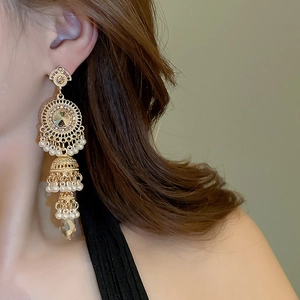 Side view of elegant vintage gold tassel earrings with champagne crystal and pearls
