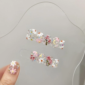 Hand-painted 3D floral press-on nails with rose and daisy patterns on glitter base
