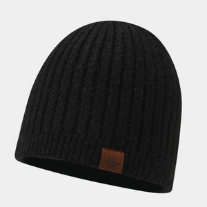 Detail of black ribbed knit beanie featuring a brown leather patch with a snowflake logo