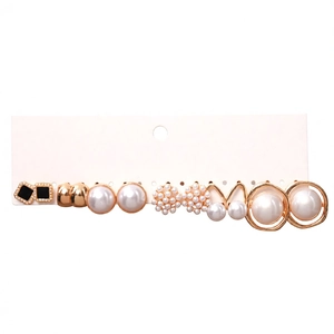 Set of 7 gold-toned stud earrings with faux pearls and floral designs on white card