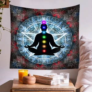 Detail of meditation tapestry with chakra silhouette and blue mandala hanging on bedroom wall