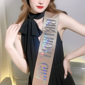 Detail of glitter champagne gold birthday girl sash with holographic text on model
