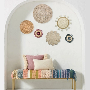 Detailed close-up of bohemian woven wall decor set with natural seagrass and colorful tassels