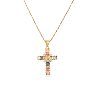Close-up of gold plated cross pendant with colorful rectangular zircon gemstones