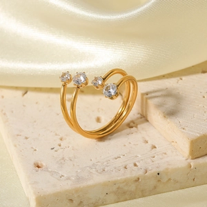 Elegant gold double-layer open ring featuring round white zircons on silk background