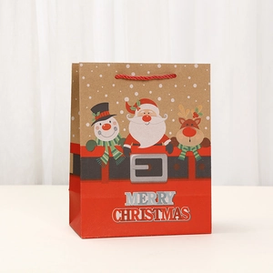 Detail of Christmas paper gift bag featuring Santa and snowman with red rope handles