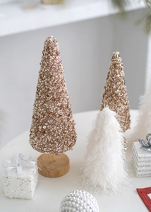Close-up of champagne gold sequin and white pearl mini Christmas tree decorations