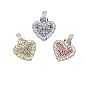 Detailed close-up of heart-shaped pendants in silver, gold, and rose gold with pavé zircons