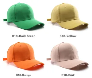 Detail view of four solid color baseball caps in dark green, yellow, orange and pink