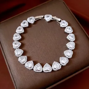 Luxurious heart-shaped zircon bracelet with pavé setting on a brown jewelry box
